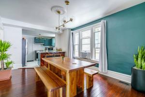 a dining room with a wooden table and a kitchen at Short North Convention Private Parking Pets! in Columbus