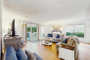 a living room with a couch and a tv at Queens Grant 653 in Hilton Head Island