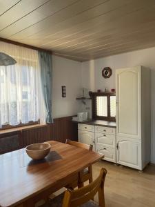 a kitchen with a wooden dining table and a kitchenventory at Ferienwohnung Susanne in Burglengenfeld +12 photos