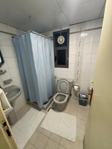 a bathroom with a toilet and a sink at Top Hotel Apartments in Al Ain