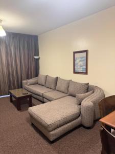 a living room with a couch and a table at Top Hotel Apartments in Al Ain +43 photos