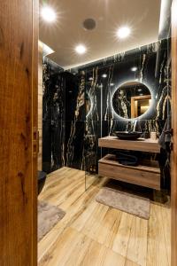 a bathroom with a sink and a mirror at Beni Deluxe in Plovdiv +14 photos
