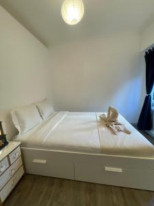 a white bed with a hat on top of it at centre Golf Juan - beach & train station in Vallauris