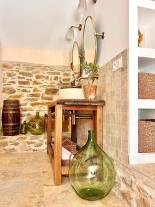 a bathroom with a sink and a mirror at Authentique bergerie en pierre avec jacuzzi privé piscine et massages La grange des amoureux in Le Beausset