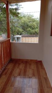 an empty room with a balcony with a large window at Casa de david in Máncora