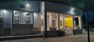 a house at night with the lights on at Silk Mbare Guest House in Manzini