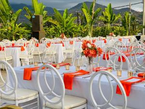 a table set up for a wedding with white tables and chairs at The Swiss Hotel Freetown in Freetown