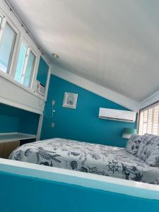 a bedroom with a bed and a blue wall at Sky Blue 321 in Cedar Key