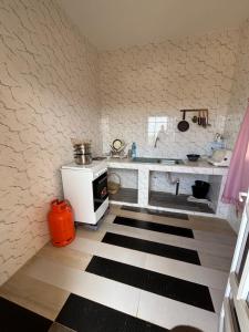 a kitchen with a counter and a stove at Residence FATIMA in Thiès