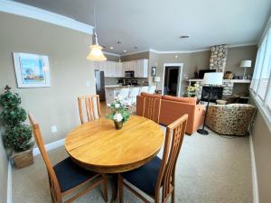 a kitchen and dining room with a wooden table and chairs at Pier Harbor #1 in Saint Ignace