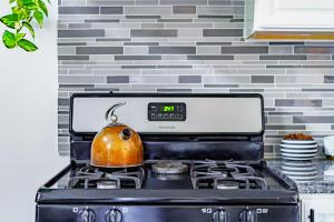a tea kettle on top of a stove in a kitchen at Short North Convention King Bed Free Parking! in Columbus