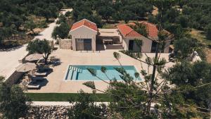 an aerial view of a house with a swimming pool at Alkinari Villa, by TK Premium Stays in Vasilikos