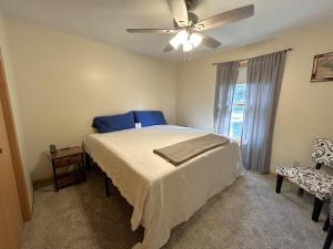a bedroom with a bed and a ceiling fan at North Country Retreat in Saint Ignace