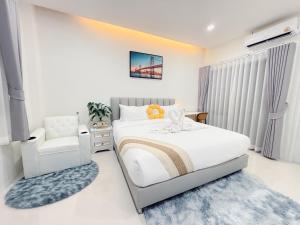 a bedroom with a bed and a chair at Tonjun residence kanjana in Ban Hua Phrong +11 photos