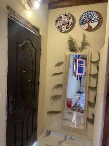baño con espejo y puerta marrón en Roof Tunis, en Tunis