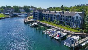 a building with boats docked at a marina at 238 Edgewater Inn in Charlevoix