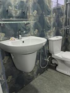 a bathroom with a sink and a toilet at Roman Residence - Unawatuna in Unawatuna