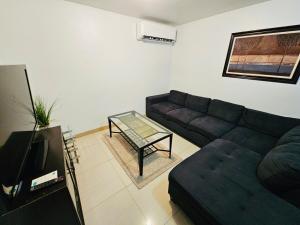 a living room with a couch and a coffee table at Joe's Place 1 bedrm, 1 bathrm in Sinajana