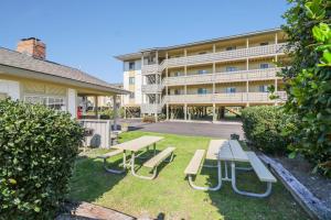 a picnic table and benches in front of a building at 33C Lighthouse Point in Tybee Island