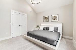 a white bedroom with a large bed in it at Short North Convention Garage Parking! in Columbus