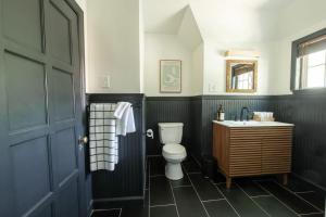 bagno nero con servizi igienici e lavandino di The Minimalist Retreat a Safe Harbor Altre 44 foto