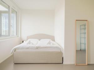 Ένα ή περισσότερα κρεβάτια σε δωμάτιο στο Stilvoll & zentral in St Gallen -WYBA Living Rio