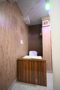a room with a bed on top of a wooden desk at The Light House in Varanasi