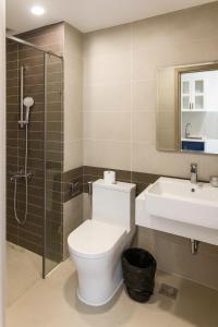 a bathroom with a toilet and a sink and a shower at DFour River Gate Deluxe Apartment by the River in Ho Chi Minh City