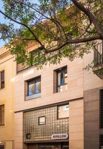 a building with windows on the side of it at BYPILLOW House in Barcelona