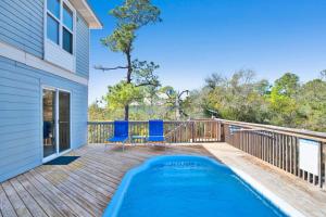 a deck with a swimming pool on a house at Private Beach and Pool in Gulf Shores