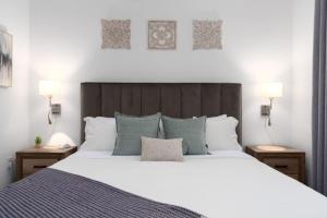 a bedroom with a large white bed with two lamps at Stylish Stay Off I-65, Pets Welcome in Acton +59 photos