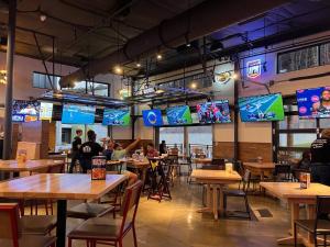 people sitting at tables in a restaurant with televisions at Stylish Stay Off I-65, Pets Welcome in Acton
