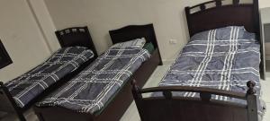 two beds sitting next to each other in a room at شقة جميلة in Irbid
