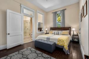 a bedroom with a bed and a large window at Historic Birmingham 4 BR 3 Bath in Birmingham