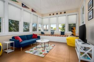 a living room with a blue couch and a table at Historic Birmingham 4 BR 3 Bath in Birmingham