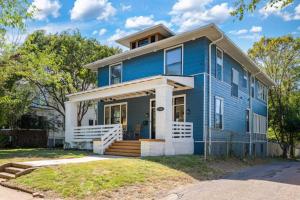 a blue house with a front porch and stairs at Historic Birmingham 4 BR 3 Bath in Birmingham