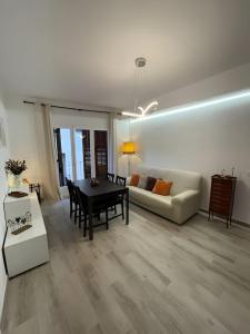 a living room with a table and a couch at Habitación Sant Jeroni en Casa Camí de les Aigües Monistrol de Montserrat in Monistrol +3 photos