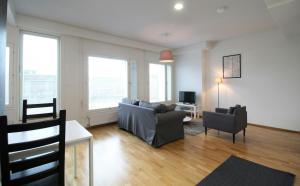 a living room with a couch and two chairs at Central Studio for 2 in Lahti