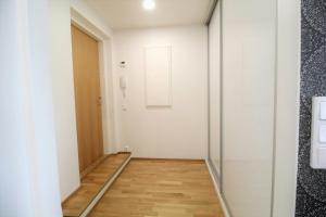 a hallway with a door and a wooden floor at Central Studio for 2 in Lahti