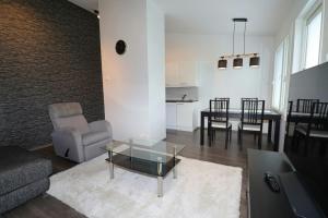 a living room with a couch and a table at Convenient Apartment for 2 with Sauna in Pori