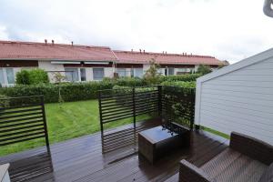 a deck with a bench and a table at Convenient Apartment for 2 with Sauna in Pori +6 photos