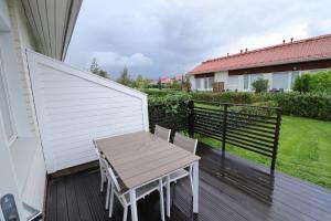 a wooden table and chairs on a balcony at Convenient Apartment for 2 with Sauna in Pori