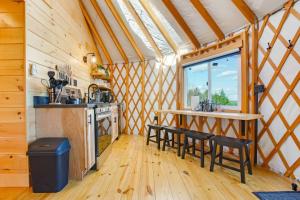a kitchen with a table and chairs in a cabin at Sunrise Sanctuary -Modern Yurt in Brookville +20 photos