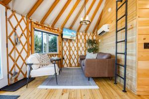 a living room in a tiny house at Sunrise Sanctuary -Modern Yurt in Brookville