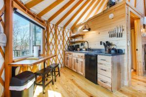 a kitchen with a sink and a counter in a cabin at Adventure Abode - Modern Yurt in Brookville +20 photos