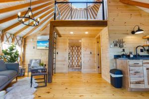 a tiny house with a kitchen and a living room at Starlit Haven - Modern Yurt in Brookville