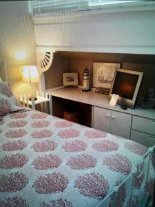 a bedroom with a bed and a desk with a computer at Lazy Shell Condo 325 in Cedar Key