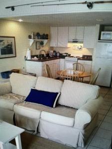 a living room with a couch and a kitchen at Lazy Shell Condo 325 in Cedar Key