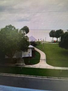 a house on the side of the road with the beach at Lazy Shell Condo 325 in Cedar Key