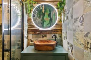 a bathroom with a wooden sink and a mirror at Jungle & Sauna in Chaville +12 photos